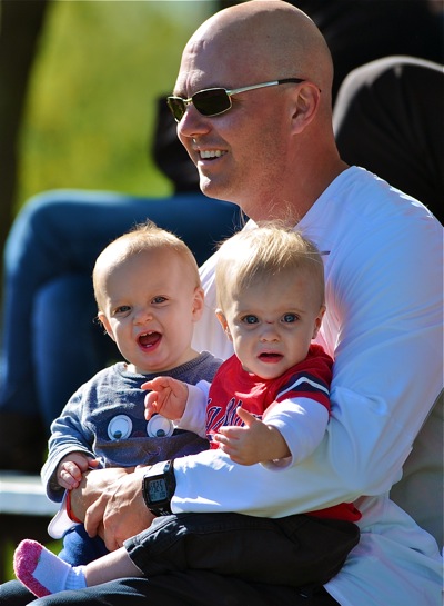 Family affair...Coldwater assistant football coach Mark Bruns enjoys Monday's game with twin sons, Joe and Drew.