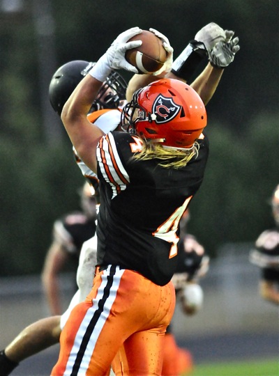 Coldwater's Kraig Schoenherr outduels a Minster defender for catch in the Cavaliers' 28-0 win.