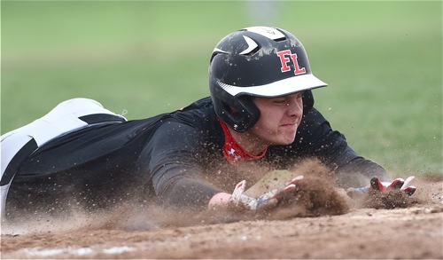 Loramie's Carter Siegel stretch for the plate during the Redskins' fourth inning outburst.