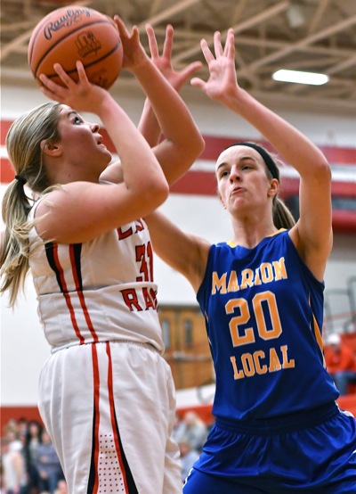 Marion's Kara Evers (#20, above) got the Flyers out to comfortable lead with 11 first half points, but spent much of the second half on the bench with foul trouble.