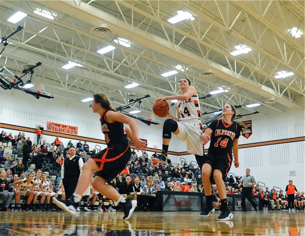 Minster's Rosie Westerbeck charges to the rim for two of her nine points.