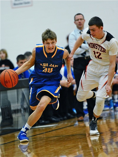St. John's Colllin Will (#30) speeds past Minster's Aaron Ernst in Friday's MAC win over the Wildcats.