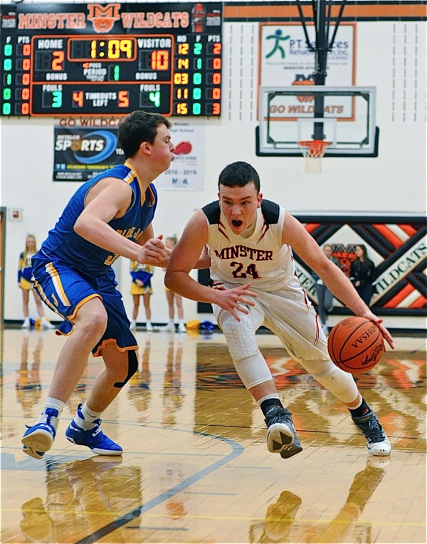 Minster's Aaron Ernst drives past a St. John defender.