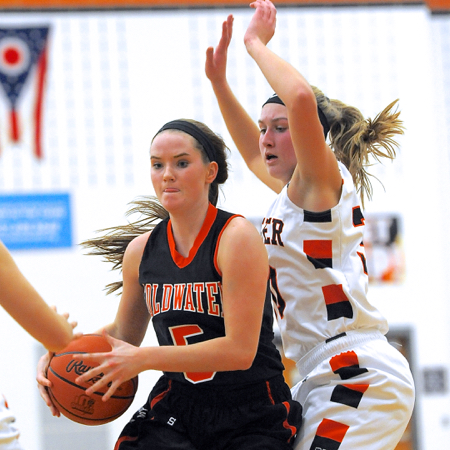 Minster's defense surrounds Coldwater's Olivia Harlamert.