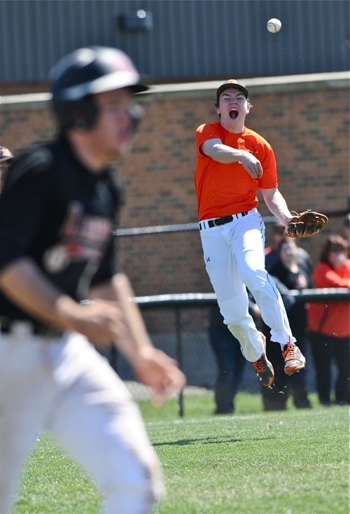 Aaron Ernst makes a field-and-throw barehand play from third base after he left the mound in the fifth inning.