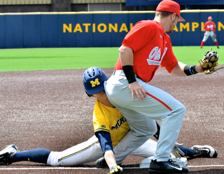 Brady Cherry's tag attempt is late to retire Michigan's Jimmy Kerr.