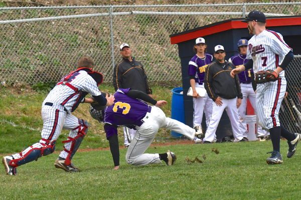 Piqua's catcher Travis Smith tags Damon Dues out midway in a rundown between third base and home plate.