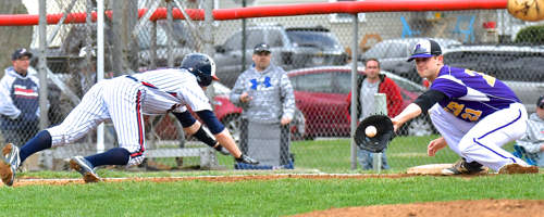Butler's Dolen Fultz tags out a Piqua runner at first between pitches.