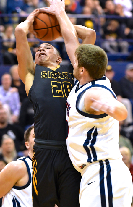 Nate Monnin makes it tough for Andre Gordan to get it to the hoop.