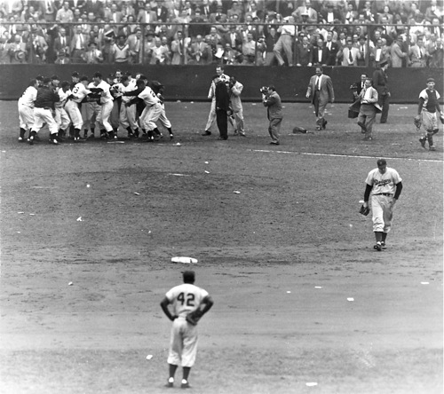 An iconic New York press photo from the climax of the Giants-Dodgers playoff game in October, 1951. Dodger second baseman Jackie Robinson (#42) watches the Giants celebrate Bobby Thomson's home run while pitcher Ralph Branca walks away in dejection.