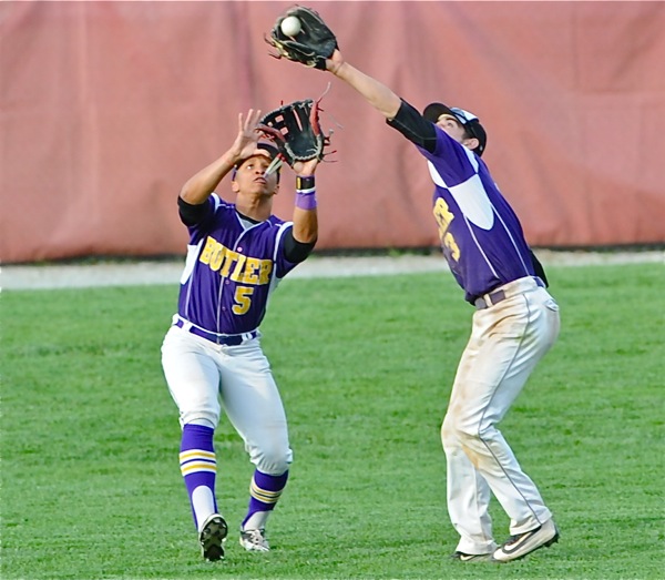 Butler shortstop Damon Dues reaches in front of teammate Henry Barwick to make a catch in the seventh inning.