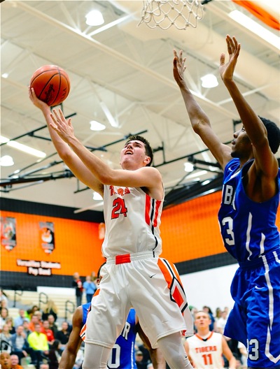 Connor Custenborder sweeps to the rim for two of his eight points.