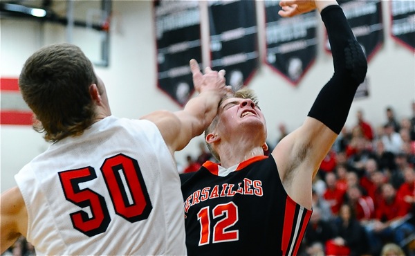 Justin Ahrens gets whacked by Tyler Siegel on a shot attempt in the first half.