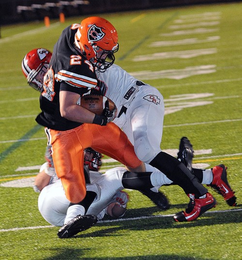 Brad Giere slashes through tacklers on his way to a touchdown in the win over Coshocton.