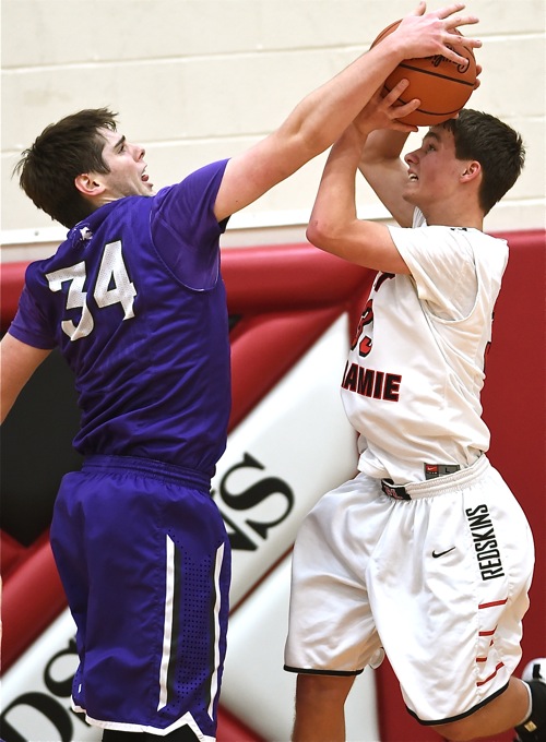 Recovery's Macaiah Cox (#34) only scored three points, but had a defensive moment of his own against Loramie's Eli Rosengarten.