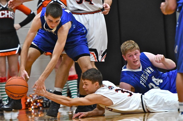 Shelby County League basketball...Jackson's Trent Platfoot fights tips the ball away from Fairlawn's Nick Brautigam.