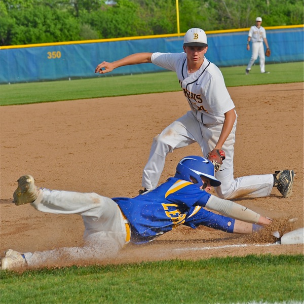 Dylan Arnold stretches to hold on to third base in the Cavaliers' sixth.