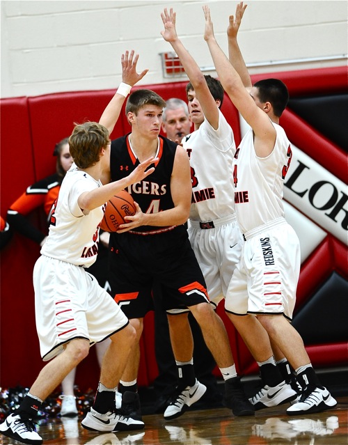 Brady Bunch...Loramie's defenders put the squeeze on JC's Brady Wildermuth, holding him to just ten points.