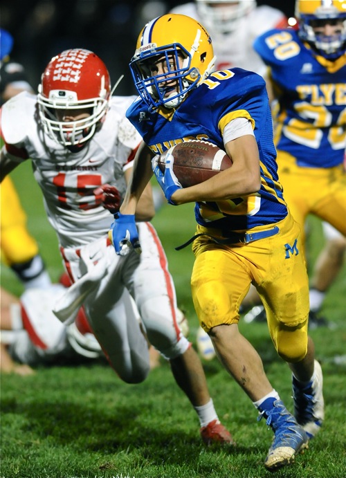 Marion's Matt Rethman bolts for yardage in the first half of Friday's win over St. Henry.