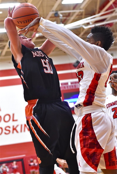 Minster's Jarod Schulze has his shot attempt stripped and discared by Lima Perry's LaMonte Nichols.