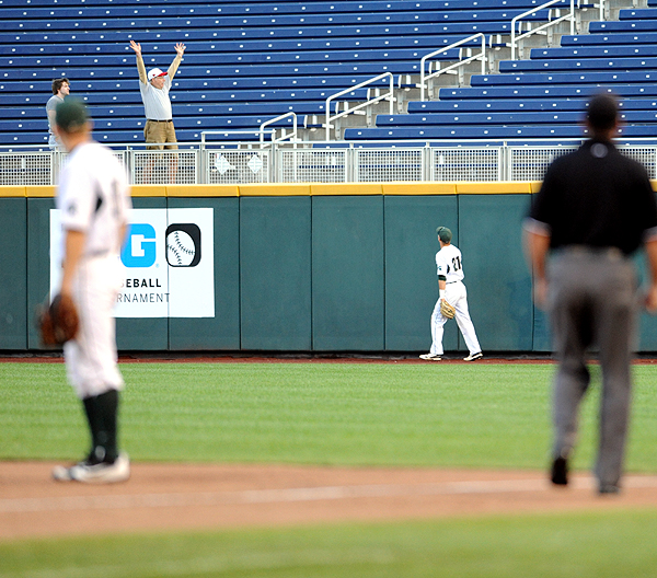 MSU right fielder Dan Chmielewski and an excited fan watch as Ronnie Dawson's tenth inning home run touches down in the outfield bleachers.