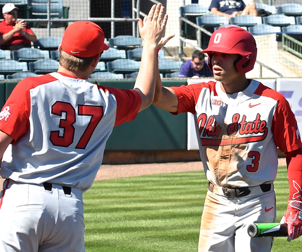 Tre' Gantt celebrates with Seth Kinker after  he delivered OSU’s first run with a single to left.