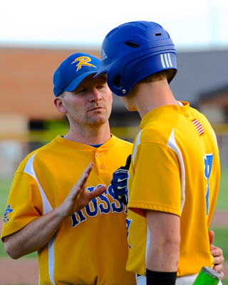 Russia coach Kevin Phlipot has a chat with Trenton Monnin before an at-bat.