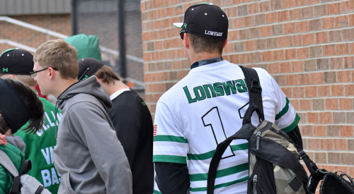 Seth Lonsway regrouping with his teammates after winning the first game against Minster in the Ft. Loramie Invitational.