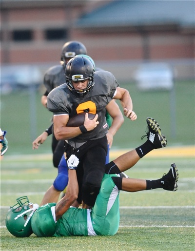 'Jackets' running back Isaiah Bowser runs through a would-be tackler on his way to first down in Thursday's scrimmage.