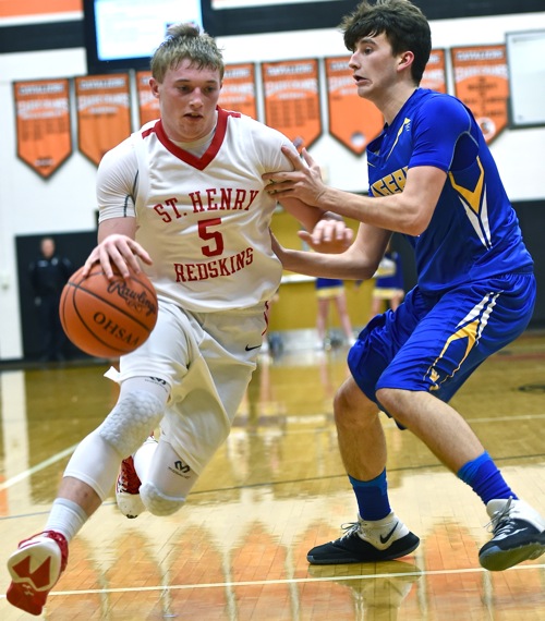 Tyler Schlarman scoots past a Goshen defender and to the rim for two of his 13 points.