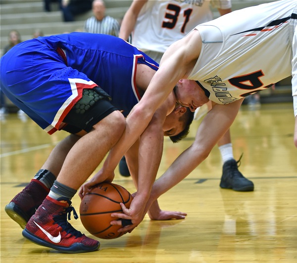 Trace Couch (left) and Coldwater's Neal Muhlenkamp butt heads over a loose ball in Saturday's game.