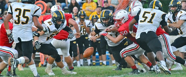 Tipp's Matt Garber (#50) looks to recover a first quarter fumble in Thursday's win over Shawnee.
