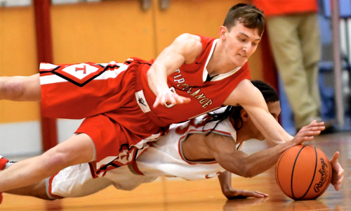 Tipp's Quenten William's (red) and Troy's Zion Taylor (white) dive airborn for a loose ball.