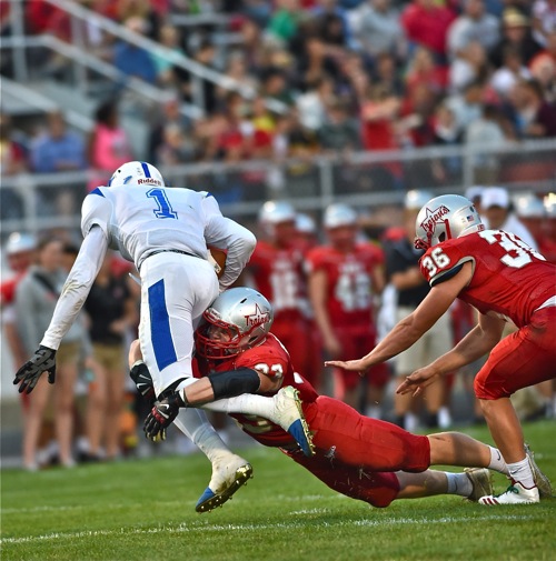 The defense was good...Troy's John Wehrkamp wraps the legs of Xenia's Meechi Harris to bring him down for a loss.