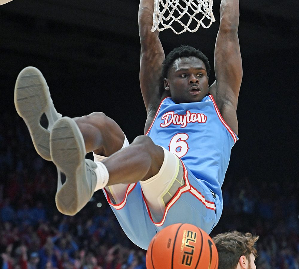 Enoch Cheeks swings on rim after a vicious slam dunk.