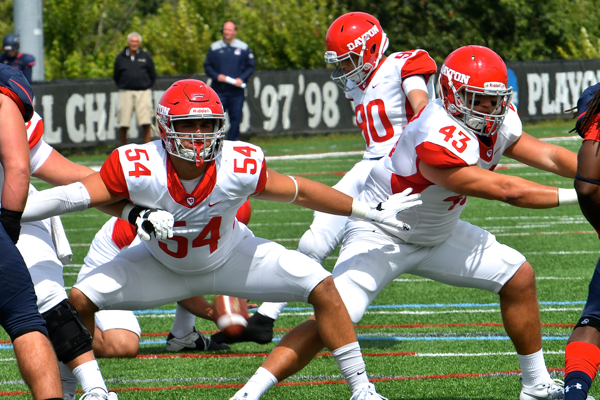 DE Nick Surges (54) and H-back Alex Kenner (43) make way for Patrick Sandler's extra points to the first TD.