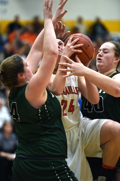 Versailles' Elizabeth Ording fights here way through Broermann (left) and McCurley (right) to score.