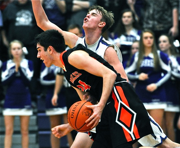Physical! Ft. Recovery's Payton Jutte's head snaps back from contact at Versailles' Connor Custenborder drives the lane.