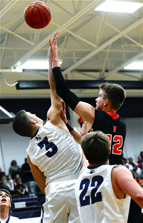 Recovery's Caleb Martin challenges Justin Ahrens at the rim during Friday's first half action.