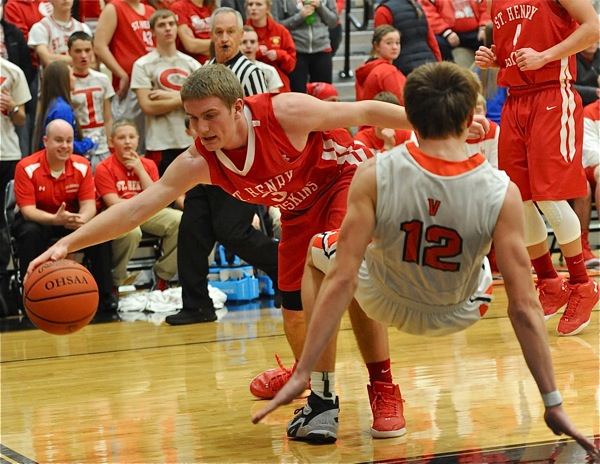 Physical...Justin Ahrens (#12) recoils from contact by St. Henry's Paul Stammen in his attempt to score.