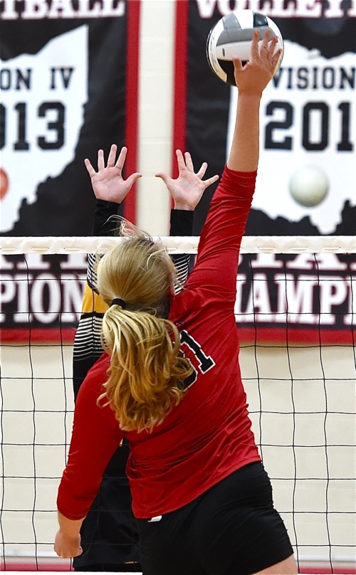 Loramie's Morgan Holscher (#31) hammers down a kill in Tuesday's win over Botkins.