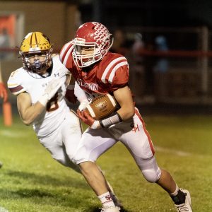 St. Henry’s Will Speck sprints past a pursuing defender